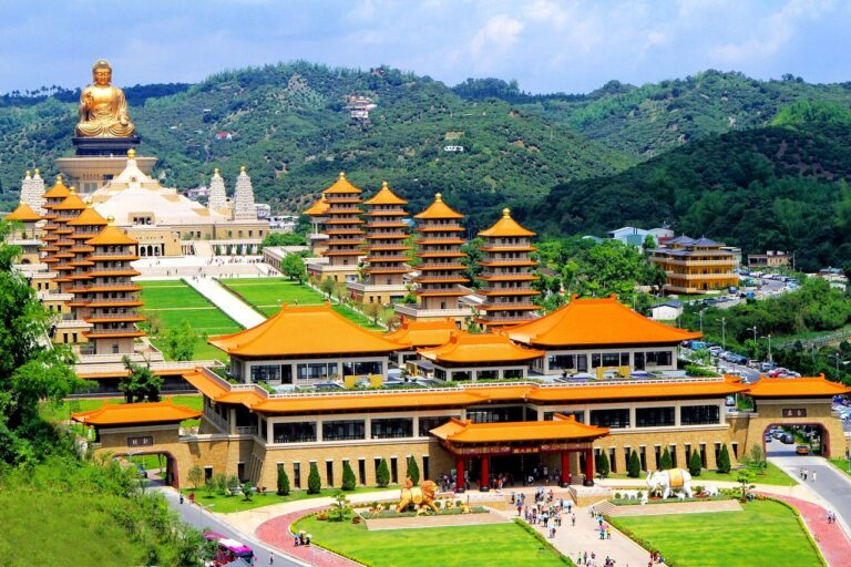 Aerial view of the Fo Guang Shan Buddha Museum in Kaohsiung, with orange-roofed halls, pagodas and a large Buddha statue