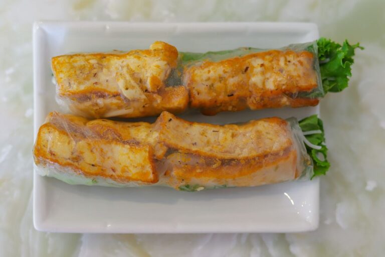 Vietnamese vegetarian spring rolls with fried tofu on a white plate